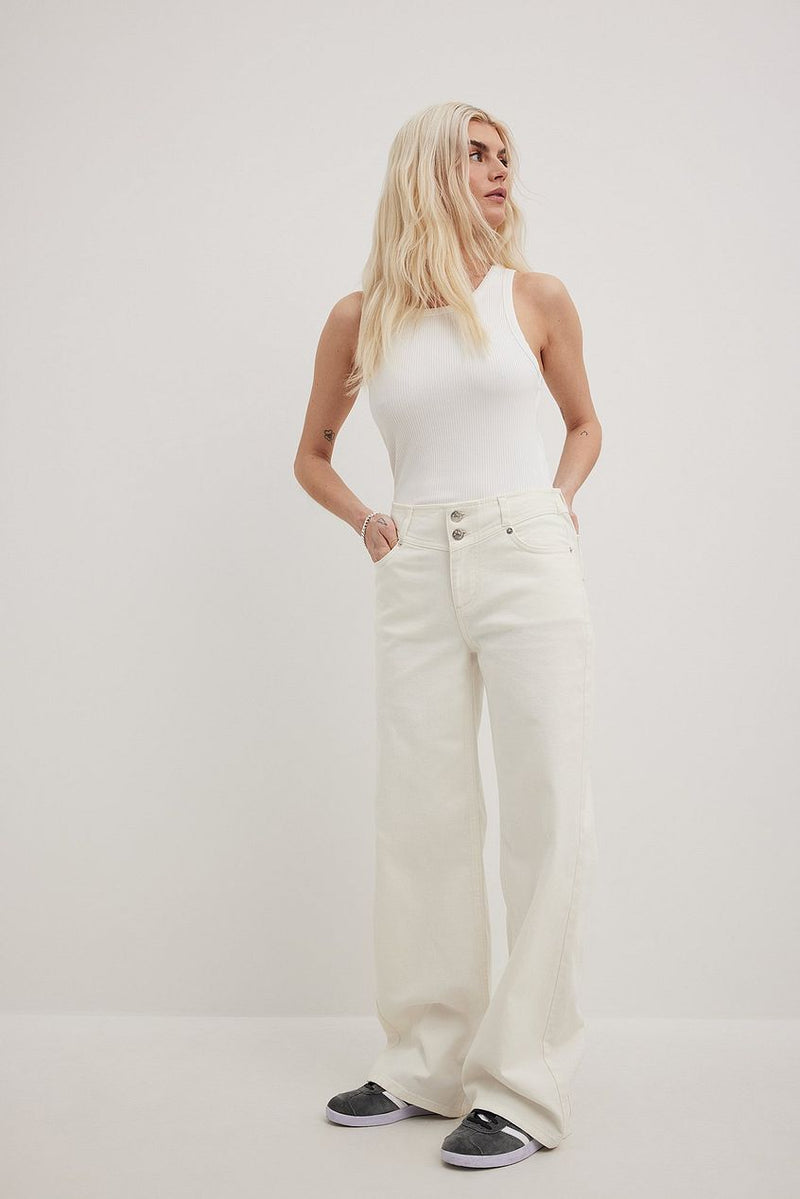 Low Waist Pocket Detail Denim - Woman wearing white tank top and high-waisted cream-colored jeans from Ace Cart, standing in plain background.