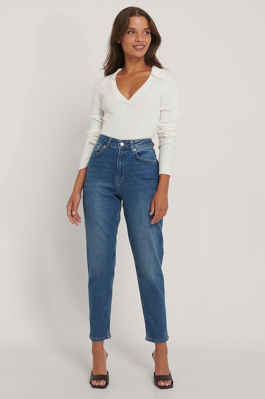 High-waist organic mom jeans with straight leg silhouette, worn by a smiling woman against a plain background.