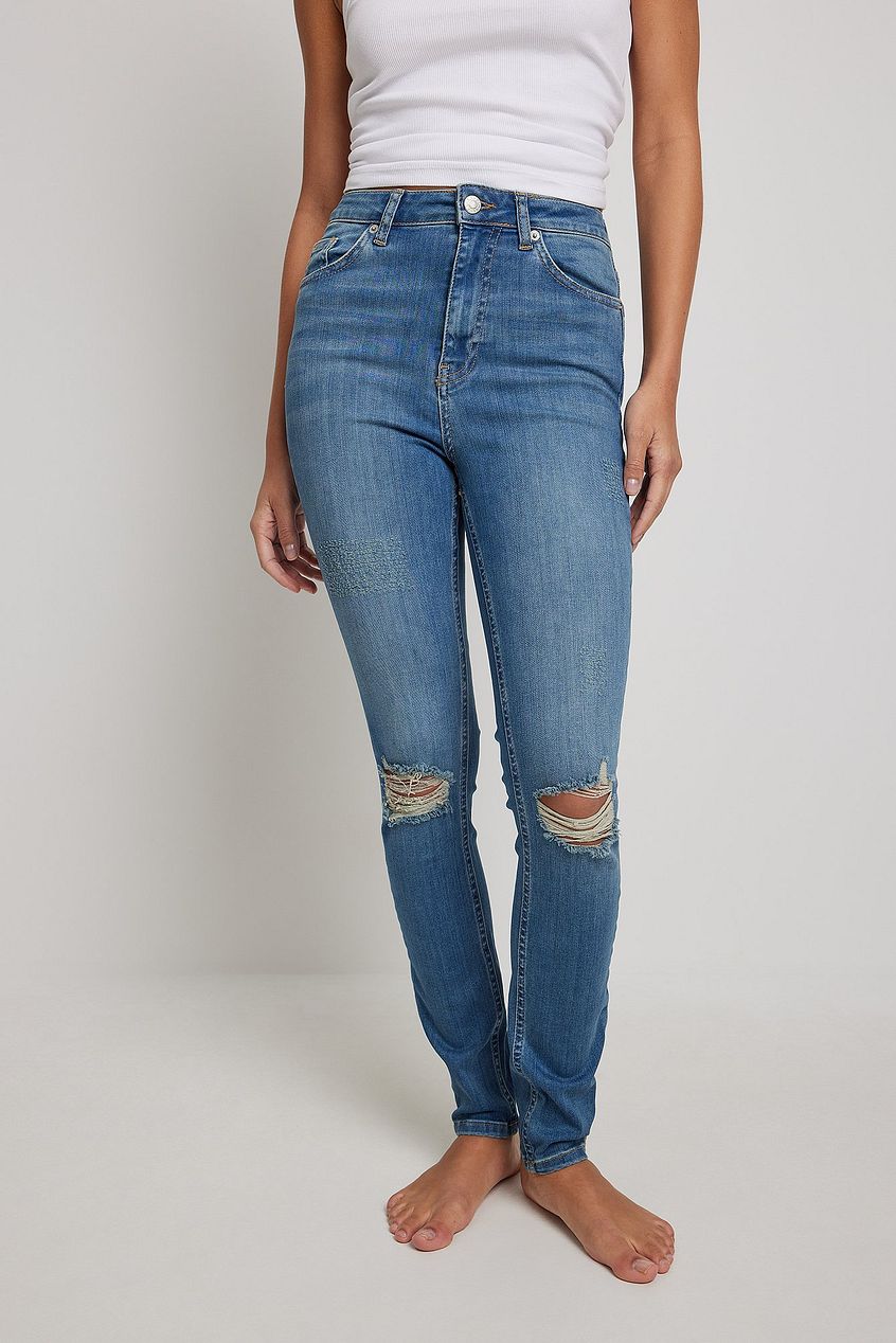 Stylish high-waist destroyed skinny jeans from Ace Cart, featuring a modern straight-leg silhouette and distressed detailing for a relaxed denim look.