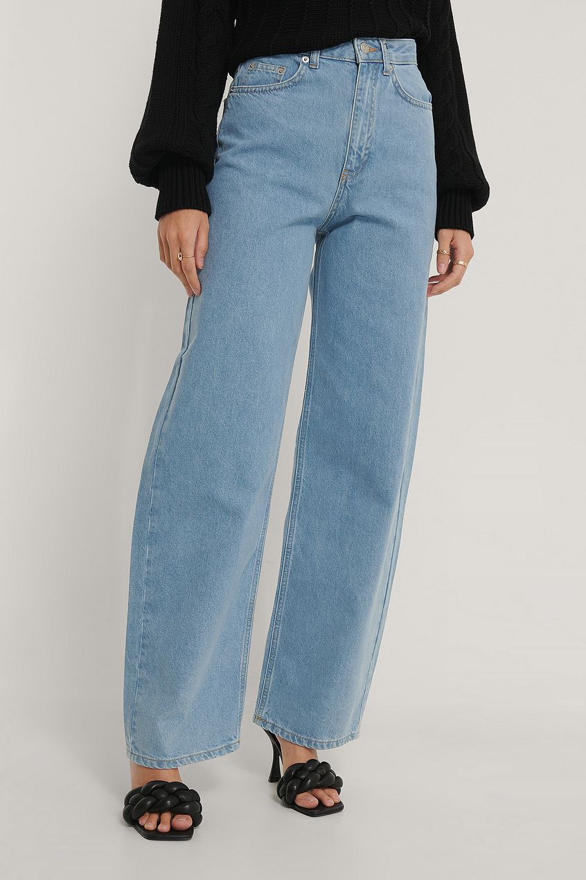 Organic extra wide leg denim jeans in light blue color, worn by a woman, displayed against a plain background.