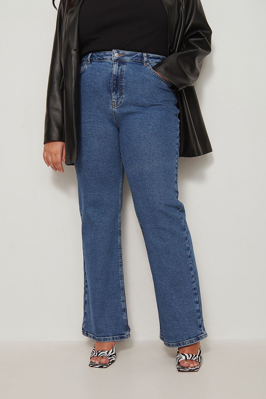 Relaxed full-length recycled denim jeans with a high waist and straight leg design, paired with a black shirt and a leather jacket, creating a stylish casual look.