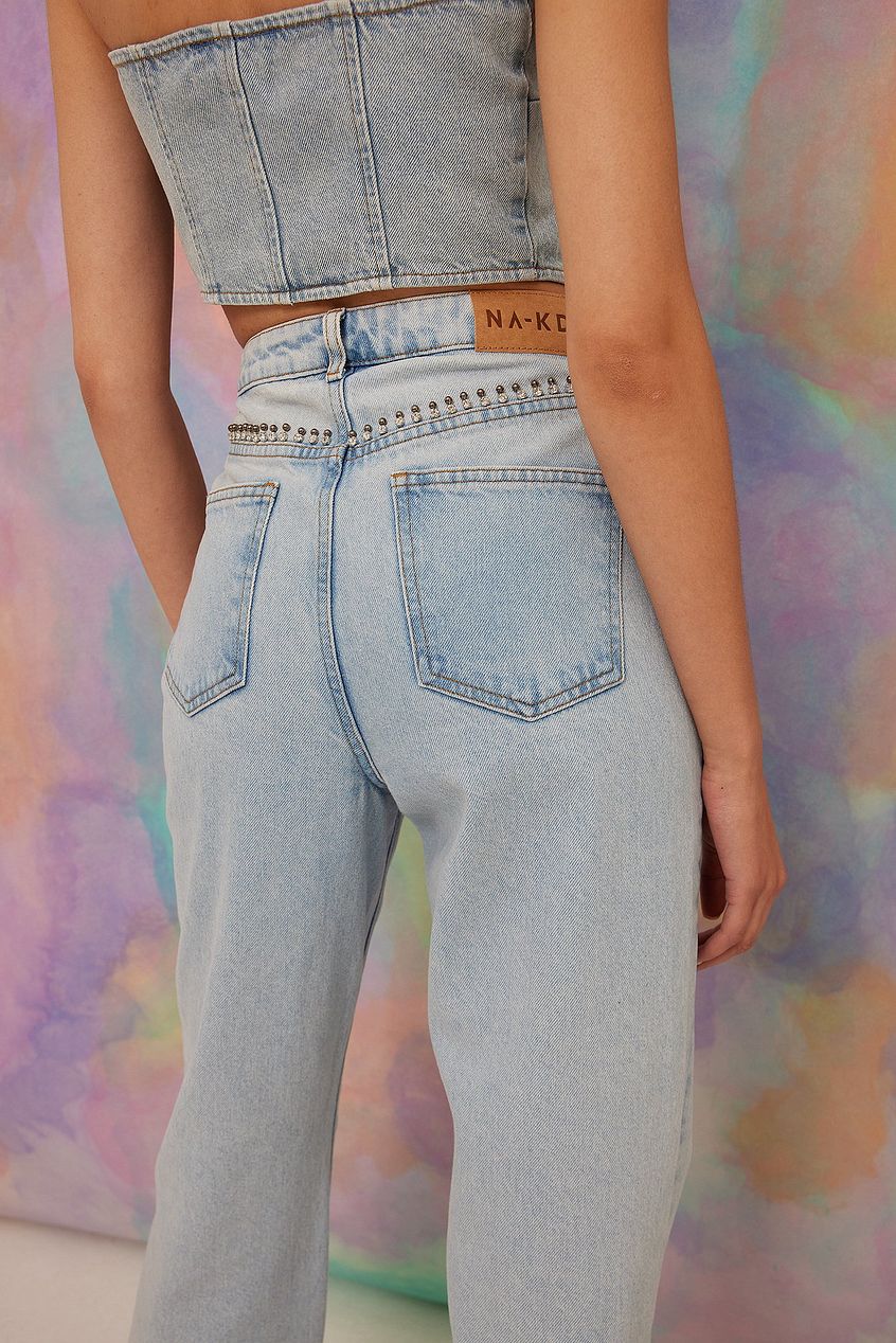 High-waist denim jeans with rhinestone detail, relaxed straight-leg fit from Ace Cart fashion brand.