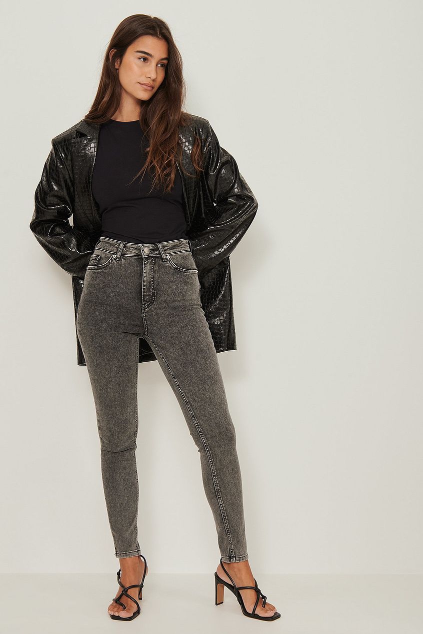 Skinny High Waist Stretch Jeans - Model wearing gray denim jeans, black crop top, and black leather jacket from Ace Cart.