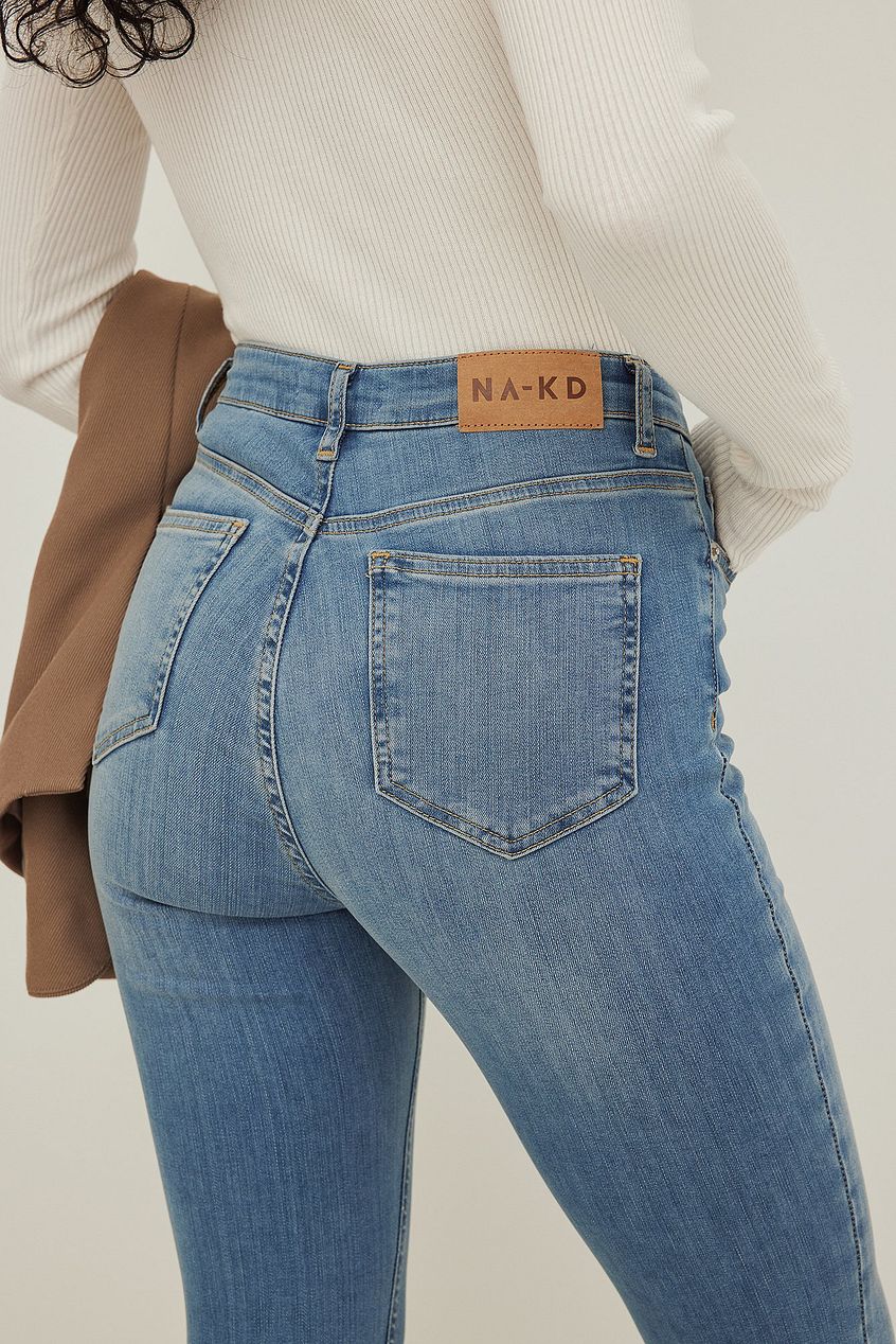 Skinny high-waist open hem denim jeans from Ace Cart, featuring a relaxed fit and classic blue wash.