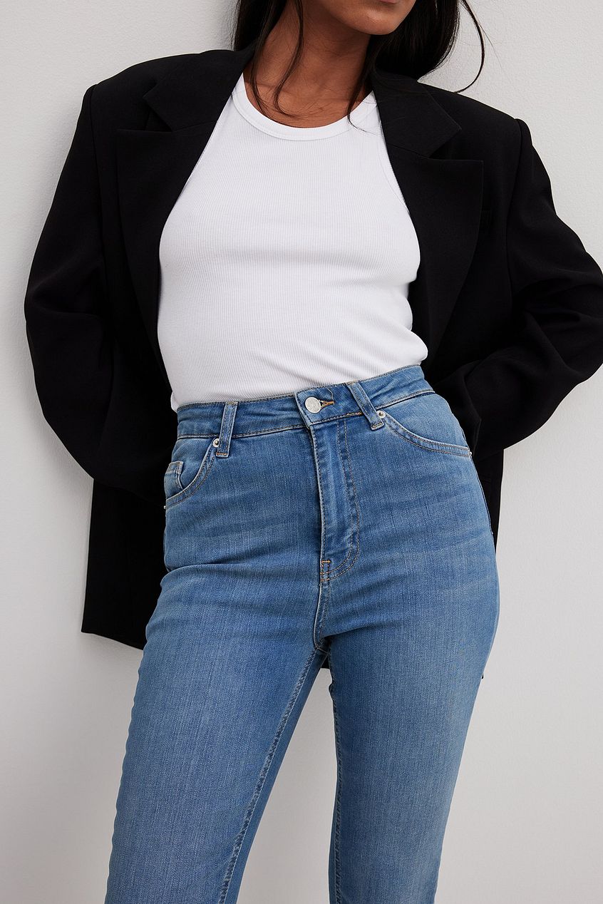 Skinny high-waist raw hem denim jeans, black blazer, white tank top, modern casual outfit