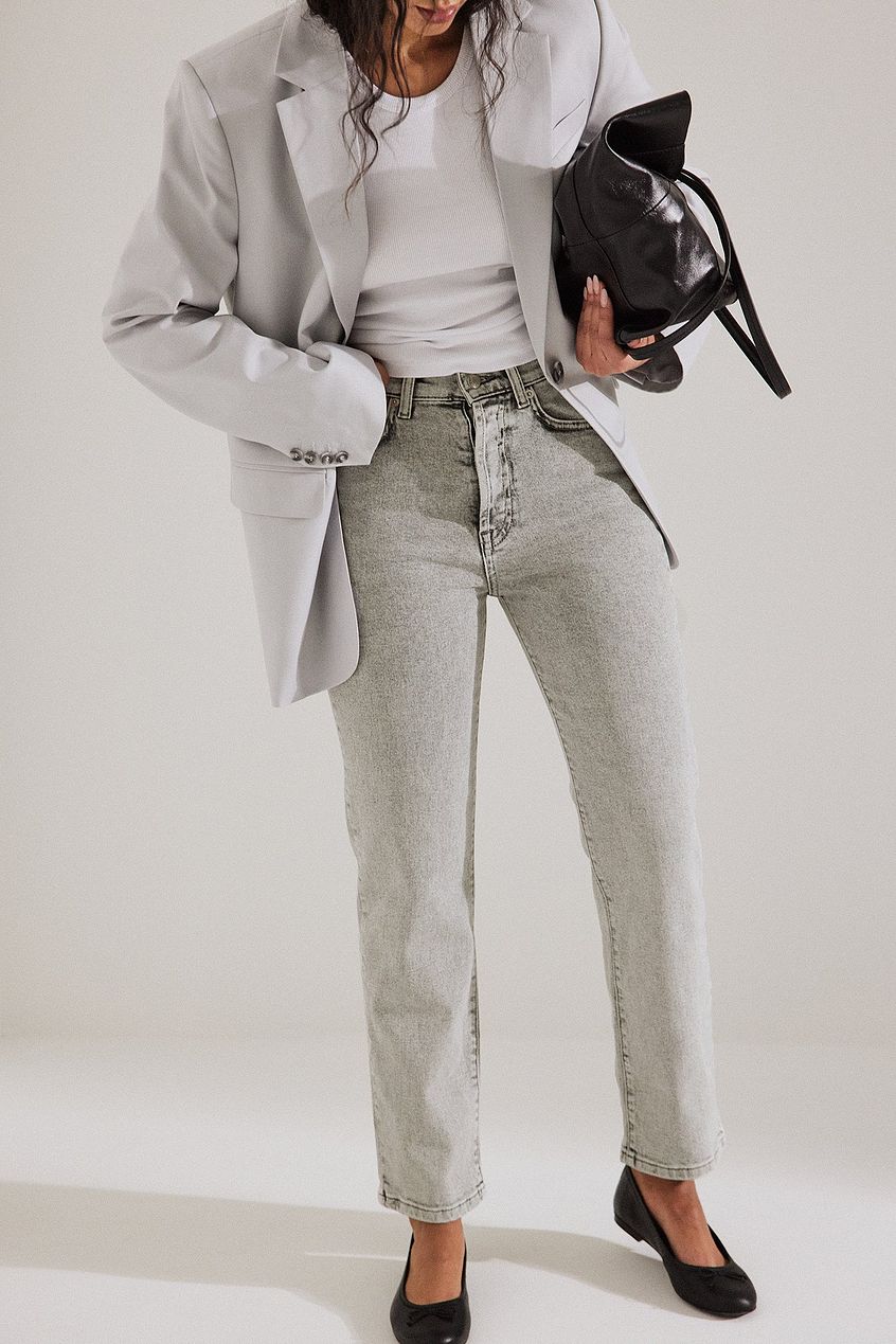 High-waisted straight-leg denim jeans from Ace Cart, paired with a neutral-colored blazer and matching top, creating a chic and stylish look.