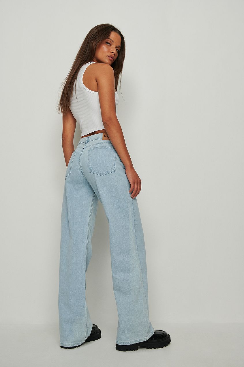 Super Low Waist Jeans from Ace Cart - Fashionable model wearing light blue denim pants with high-rise waist and wide-leg silhouette.