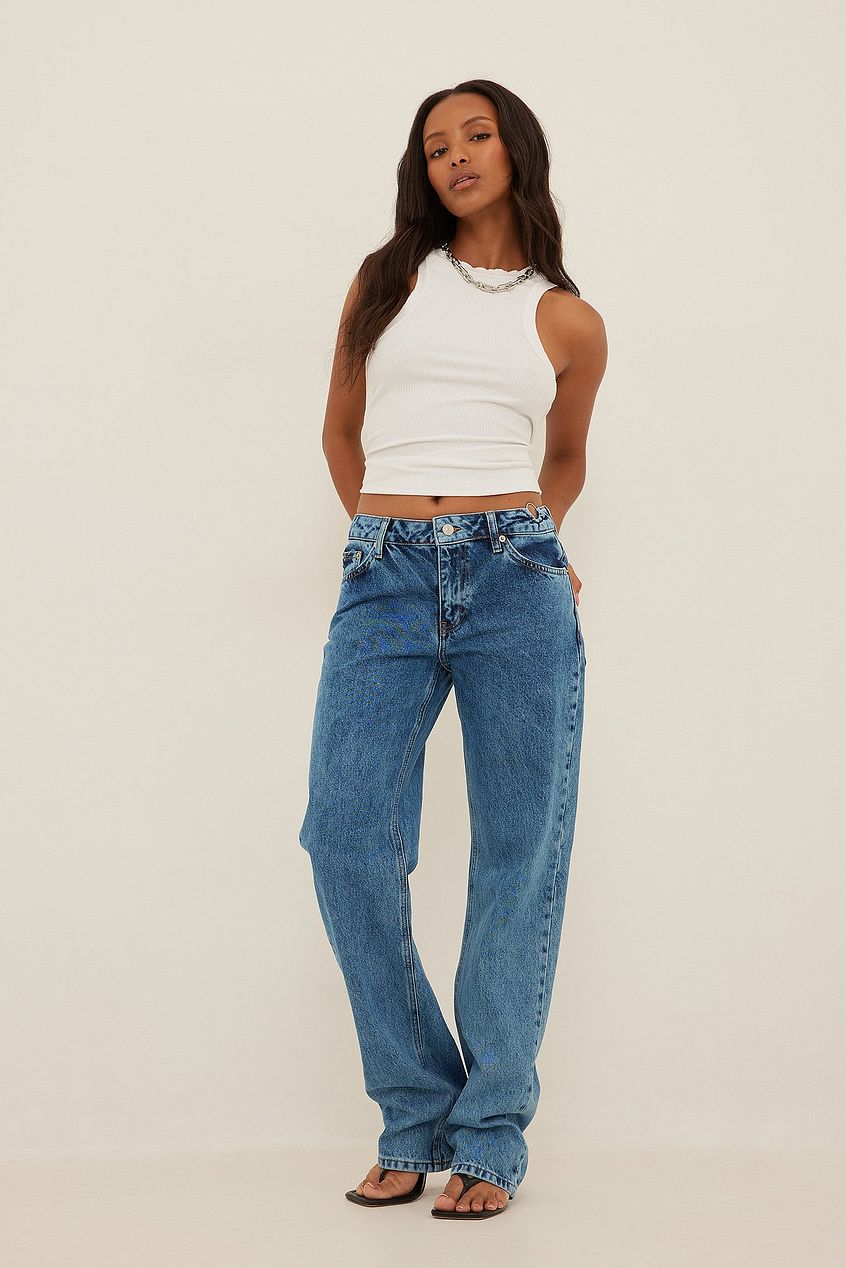 High-waist denim jeans with waist ring detail, worn by a young female model with long dark hair.