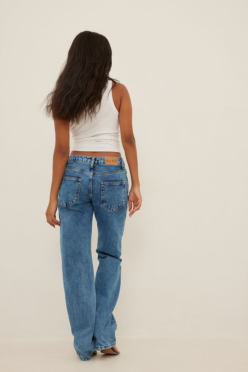 High-waisted denim jeans with waist ring detail, showcased on a female model with long, dark hair.