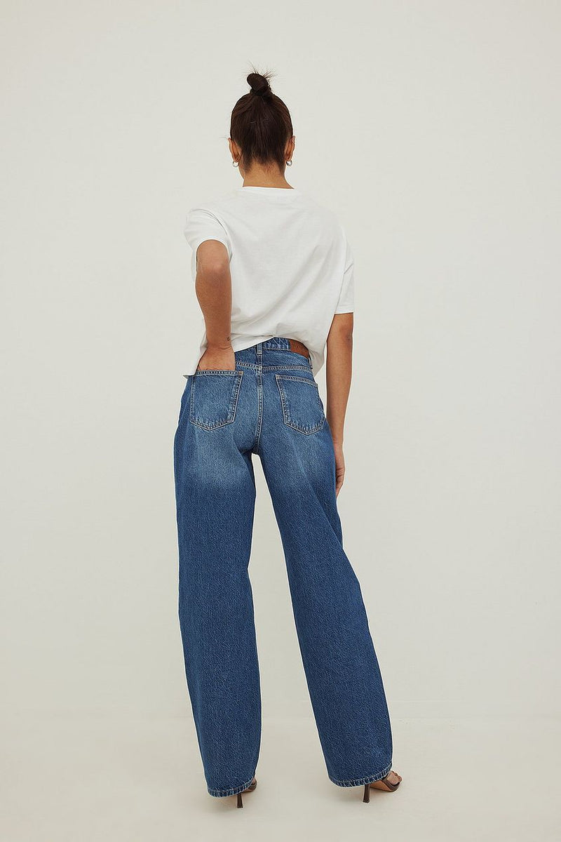 Relaxed fit wide leg denim jeans with high waistline, worn by female model from Ace Cart clothing store.