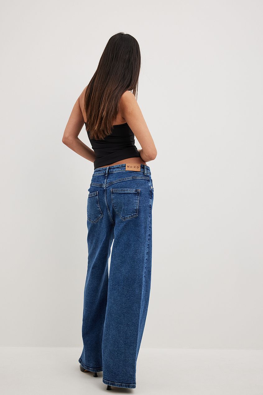 Oversized denim jeans with straight leg fit, worn by a young woman with long dark hair.