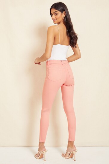 Sleek and stylish high-waisted jeggings on a young model against a plain background.