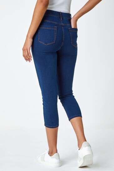 Cropped denim jeggings with high waist, showing back pocket and tapered legs