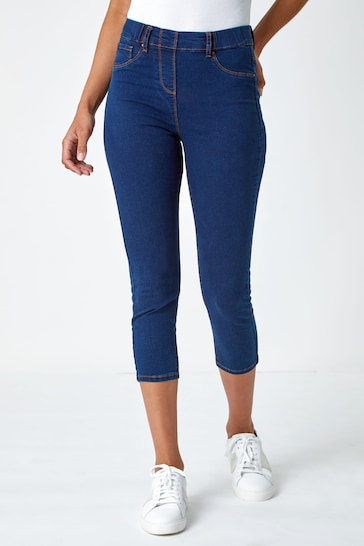 Stylish cropped dark blue denim jeggings with a high waist and slim fit, showcasing a versatile casual look.