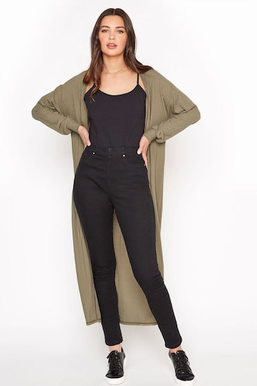 Stylish woman wearing long olive green cardigan, black tank top, and black skinny jeans. Casual yet fashionable outfit with sleek, high-waisted denim and comfortable, versatile layers.