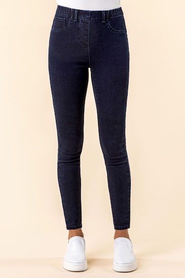 Premium dark blue high-waisted stretch jeggings with ripped knees on a white background.
