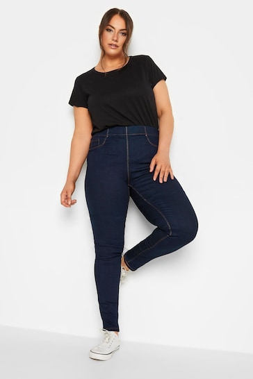 Black basic t-shirt and navy blue stretch jeggings worn by a plus-size model in a Shopify store image.