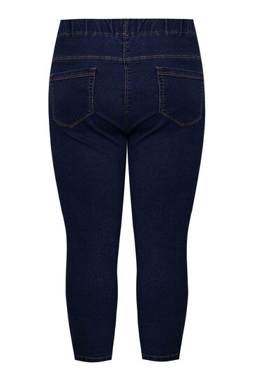Premium dark blue denim jeggings with stretch waist and knee rips on display.