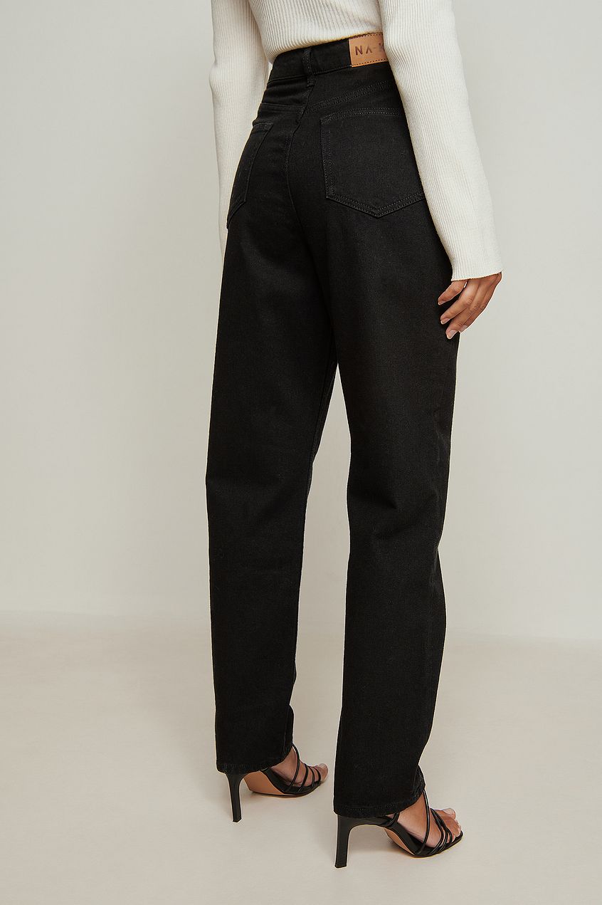 High-waisted black organic denim jeans on a female model with a neutral background.