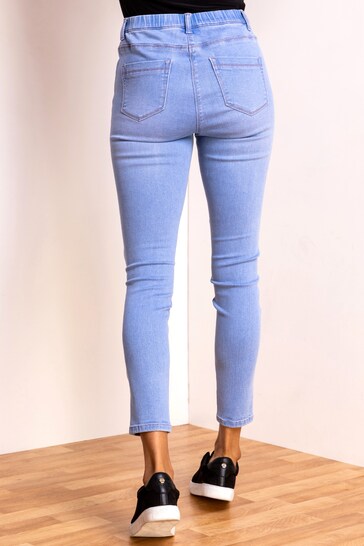 High-waisted blue denim jeggings with ripped knees, designed for a comfortable and flattering fit.