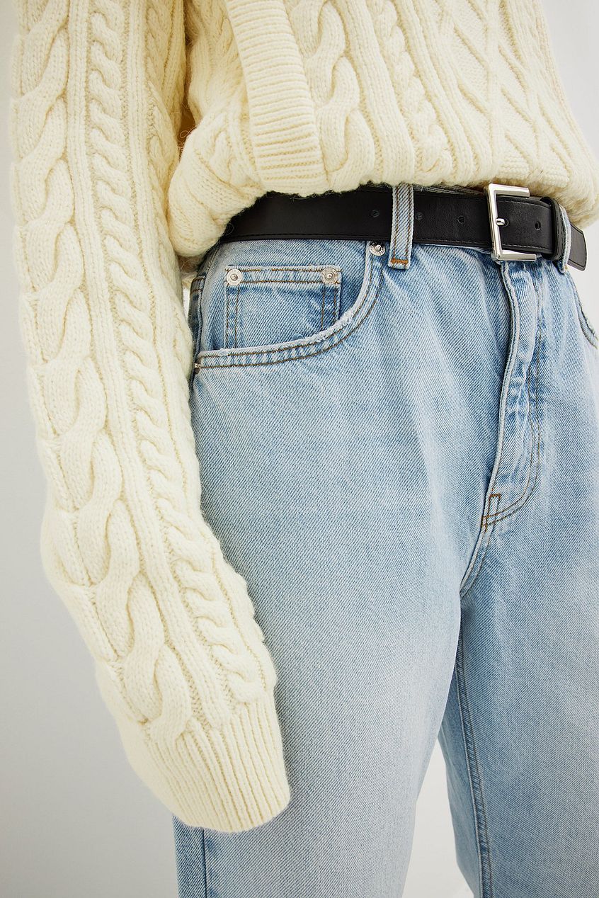 Relaxed full length jeans from Ace Cart featuring a cozy cream-colored cable knit sweater