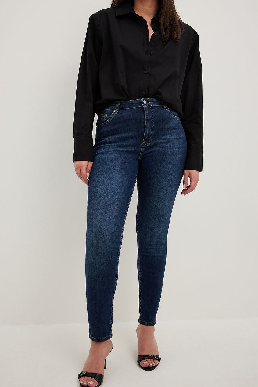 Skinny high-waist stretch denim jeans with a relaxed fit, paired with a classic black button-down shirt from Ace Cart.
