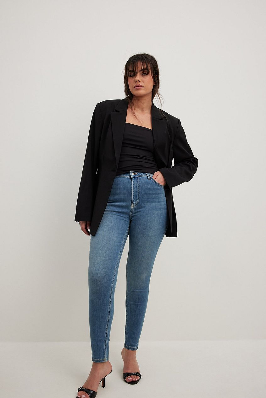 Skinny high waist stretch jeans for women, featuring a black cropped top and blazer in the image.