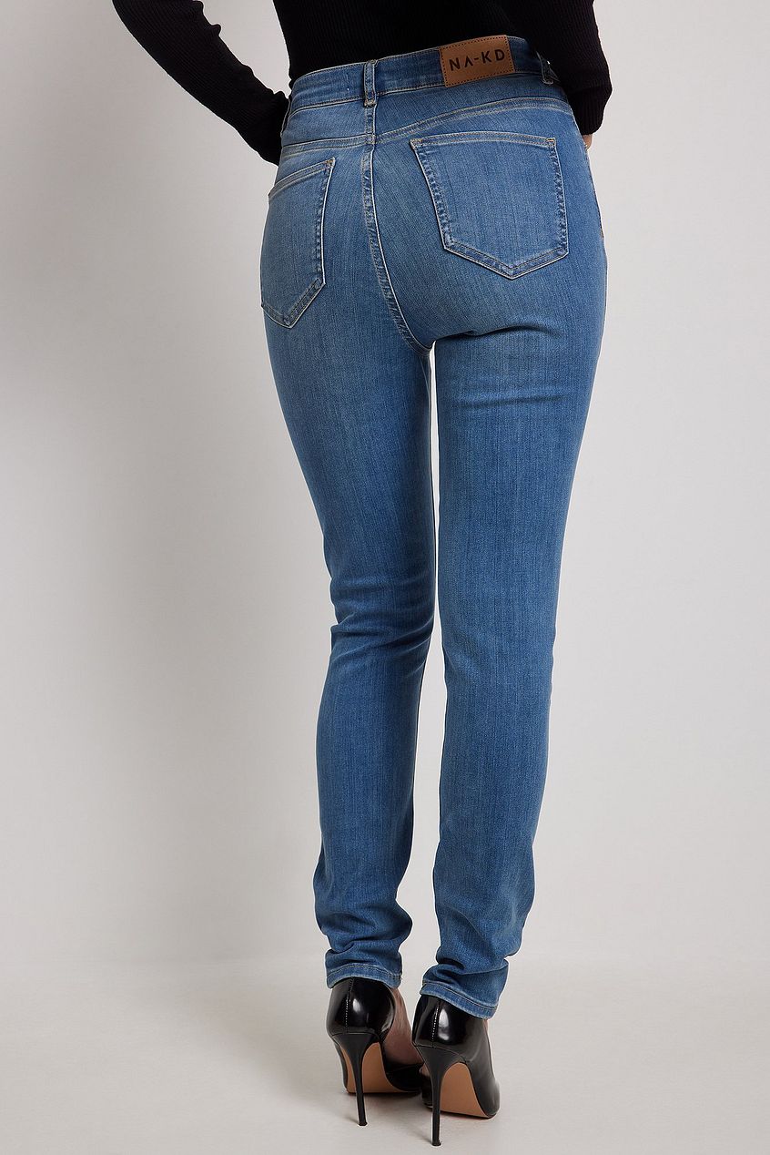 Skinny high-waist stretch denim jeans with back pocket detail on a female model.