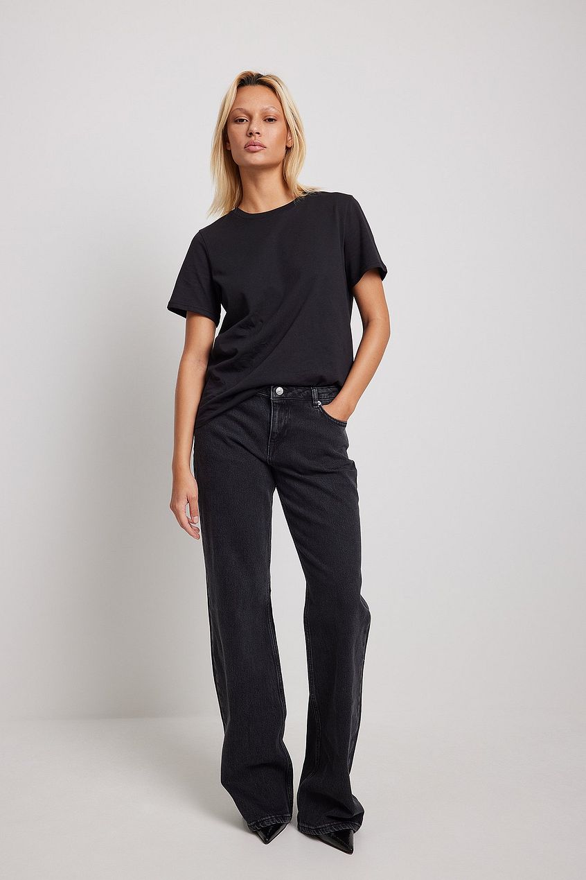 Wide leg high waisted denim jeans with a basic black t-shirt, showcasing a relaxed yet stylish look from Ace Cart.