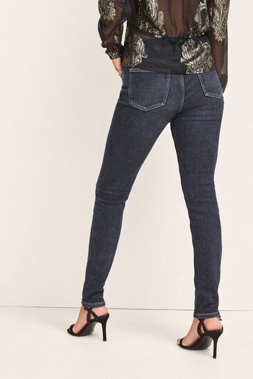Cosy Feel Skinny Jeans - Stylish dark denim jeggings with high-waist design, shown on model's legs and lower body.