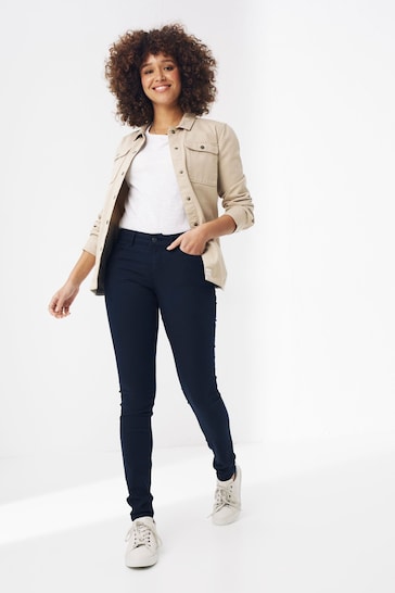 Stylish curvy woman wearing beige Fatface jeggings, standing against a plain white background.