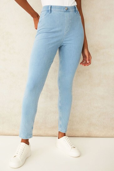 Stylish light-wash denim jeggings with a high-waisted fit, showcasing a sleek and comfortable design for the modern woman.