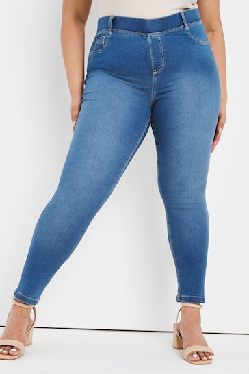 Mid blue skinny jeggings from the Ace Cart brand, featuring a stretch denim fabric and a high-waisted design, presenting a stylish and comfortable plus-size option.